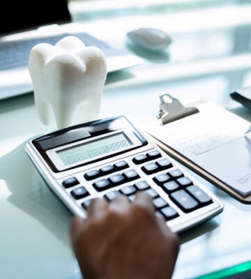 a person calculating the cost of a full mouth reconstruction