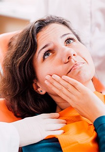 Woman with a toothache at the dentist