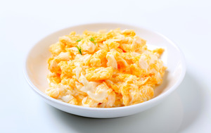 Plate of scrambled eggs with garnish